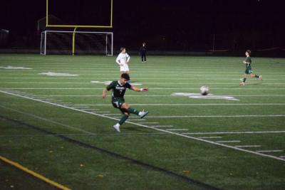 Andrew Catulo kicks the ball back into play. 