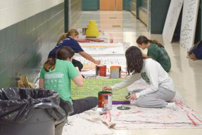 Students decorate the sets.