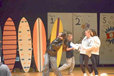 A student belts out her line.