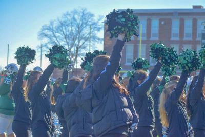 The cheerleaders get the crowd excited. 