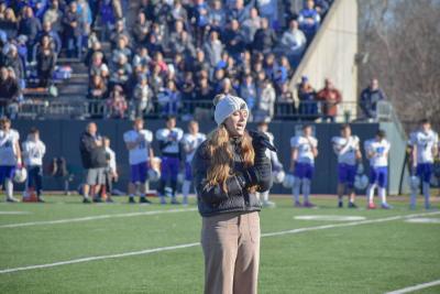 Emma Terach, a student at Dartmouth High School, sings the National Anthem. 