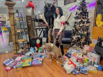 Raluca Mandrila-Viacmensky and Nico pose with Krampus. 