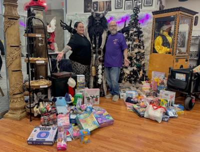 Co-owners Florrie Steele and Max Diamond pose with Krampus and the presents.