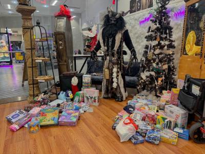 Krampus poses with all the toys raised. Photos by Kat Sheridan