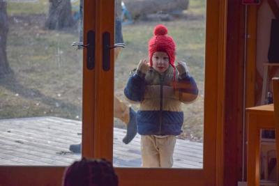 Miles McHenry, 6, looks into the building intrigued by the Kwanzaa celebration. 