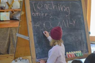 A child writes down what she will be doing to spread light in her community. 