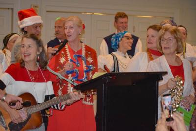 The officers and dancers lead Christmas carols.