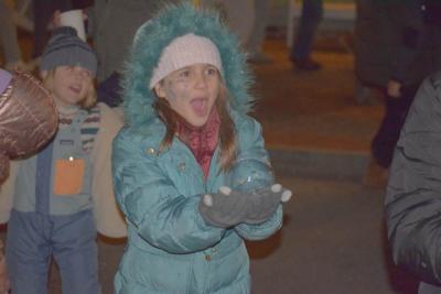 Aurea Wilson, 10, catches a bubble.