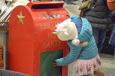 A child investigates the mailbox for Santa.