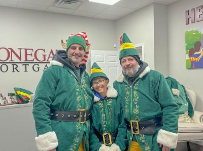 Elves Adam Barboza, Tatum Barboza and Joey Inacio pose for a photo. 
