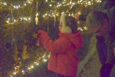 Courtney Gwozdz hangs an ornament for the Jimmy Fund. 