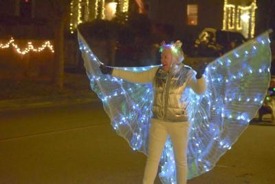 A woman dressed as a illuminated angel. 