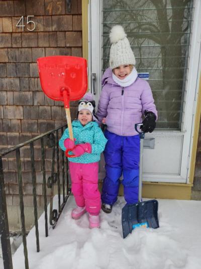 Adeline Santos and her cousin Sadie Thomas getting ready to shovel as the snow began to fall on Sunday. Source: Audra Thomas