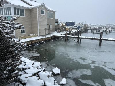 A snowy house on the water. Photo by Mari Huglin