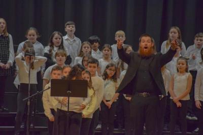 Music teacher Cameron Siegal prompts the crowd to participate. Photo by Kat Sheridan