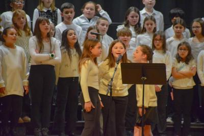 Three girls from the Potter School sing a solo during the concert. Photo by Kat Sheridan