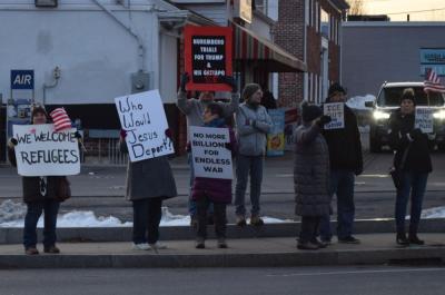A number of signs protesting the deportation of immigrants.