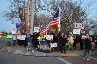 Protesters pose on the corner at the border of New Bedford and Dartmouth.