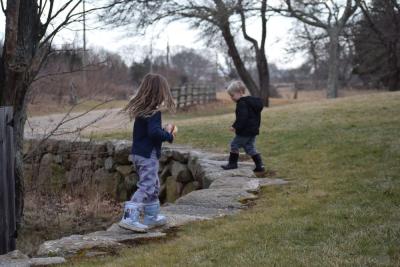 Two children run along the stone fence at Round the Bend Farm. Photos by Kat Sheridan