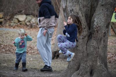 A four-year-old plays on the rope swing.