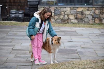 IvyRose Nelson, 8, pets the farm dog.