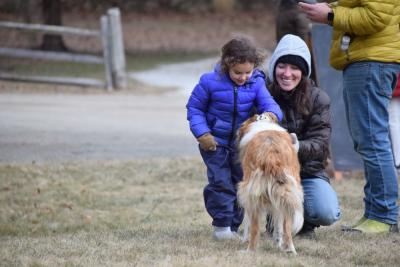 Bella, 4, and Marian Burgo pet the farm dog. 