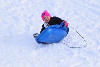 Avarey Landgrof, 7, tips over in her sled.