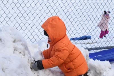 Sage Paiva, 2, plays in the snow.