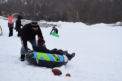 Frank Polverino III pushes Frank Polverino IV down the hill in his sled.