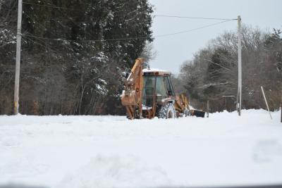 A machine gets rid of some snow.