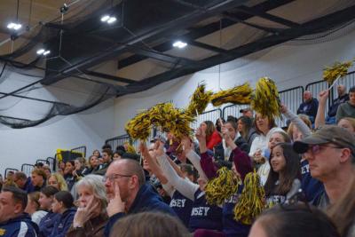 Girls from Tansey cheer with their pom poms. 