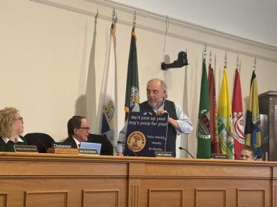 David Tatelbaum gifts Stanley Mickelson the illegally hung sign. 