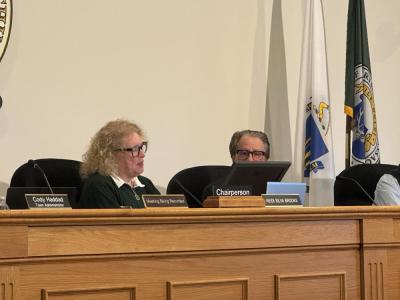 Heidi Silva-Brook gifts Stanley Mickelson his citation. 