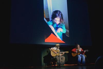 Leila Hijazi performs "Remember Me" from Encanto with photos of her as a child in the background.