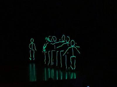 The first number featured glowing, dancing stick figures.