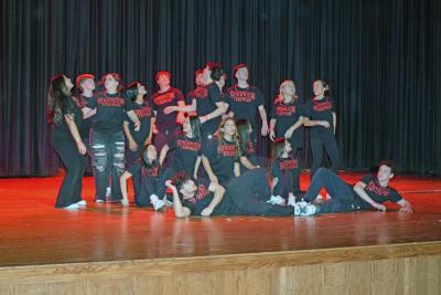 The entire cast pose at the end of  the opening dance.