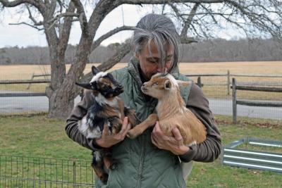 Shannon Lawrence snuggles with the baby goats. Photos by Kat Sheridan