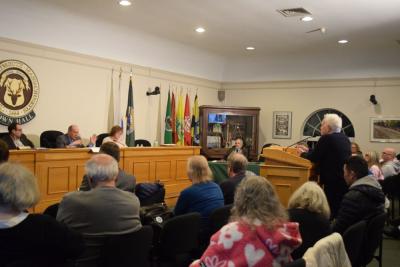 Michael Medeiros and Dave Calhoun argue over details of the proposed apartments. 