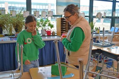 Christine Gideon and a student inspect evidence left on the desk.
