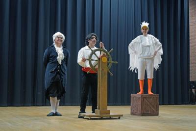 Grimsby (Hudson Igisomar), Prince Eric (Julian Lazaro) and Scuttle (Nyah Suarez) pose onstage.
