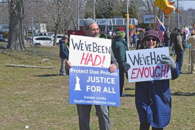 A couple shows off their signs. 