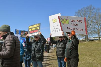 Many of the signs called for no kings.