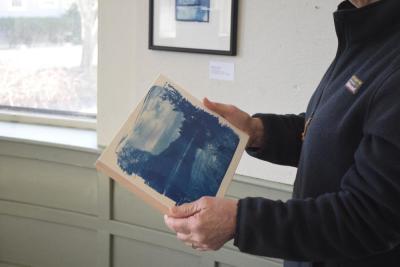 Jill Law holds one of her works. 