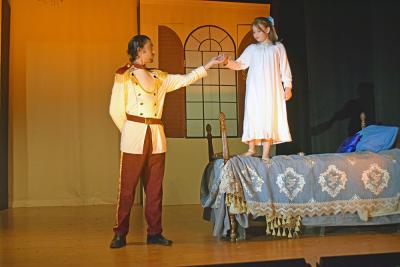 A young Anastasia goes to dance with her father. 