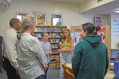 Emily Reid, Hannah Zexter and Daniella Yu explain their project about overdevelopment in town. 