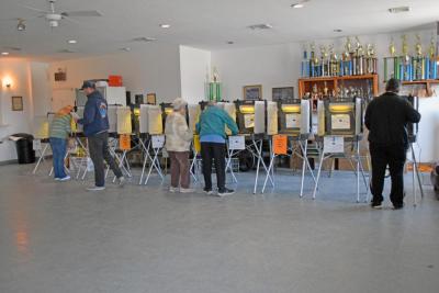Voters at the Dartmouth Youth Athletic Association fill in their ballots. 