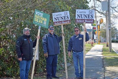 Nathan Silva and two others campaign for him outside the Council on Aging. 