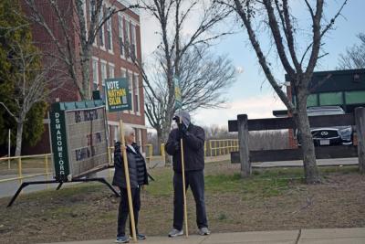Two people campaign for Nathan Silva outside Town Hall. 