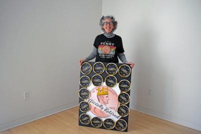 Nancy Franks with her penny retirement sign. Photo by Kat Sheridan