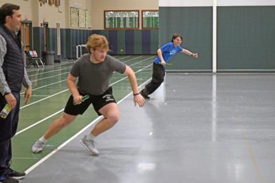 Coach John Breault watches Aidan Gendron race Jason Sullivan. Photos by Kat Sheridan
